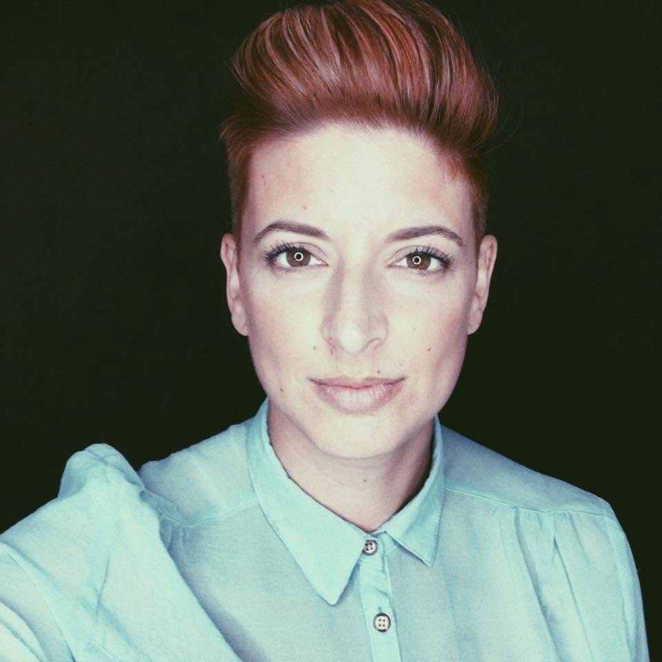 Marianne today, with short red hair and a mint shirt